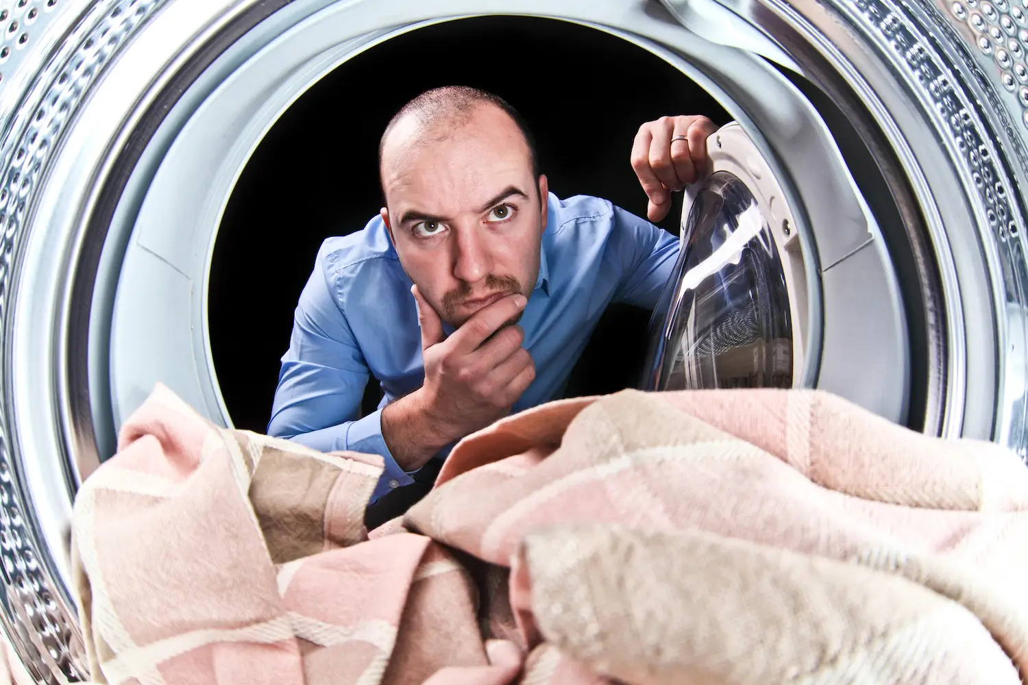 Homme regardant sa machine à laver