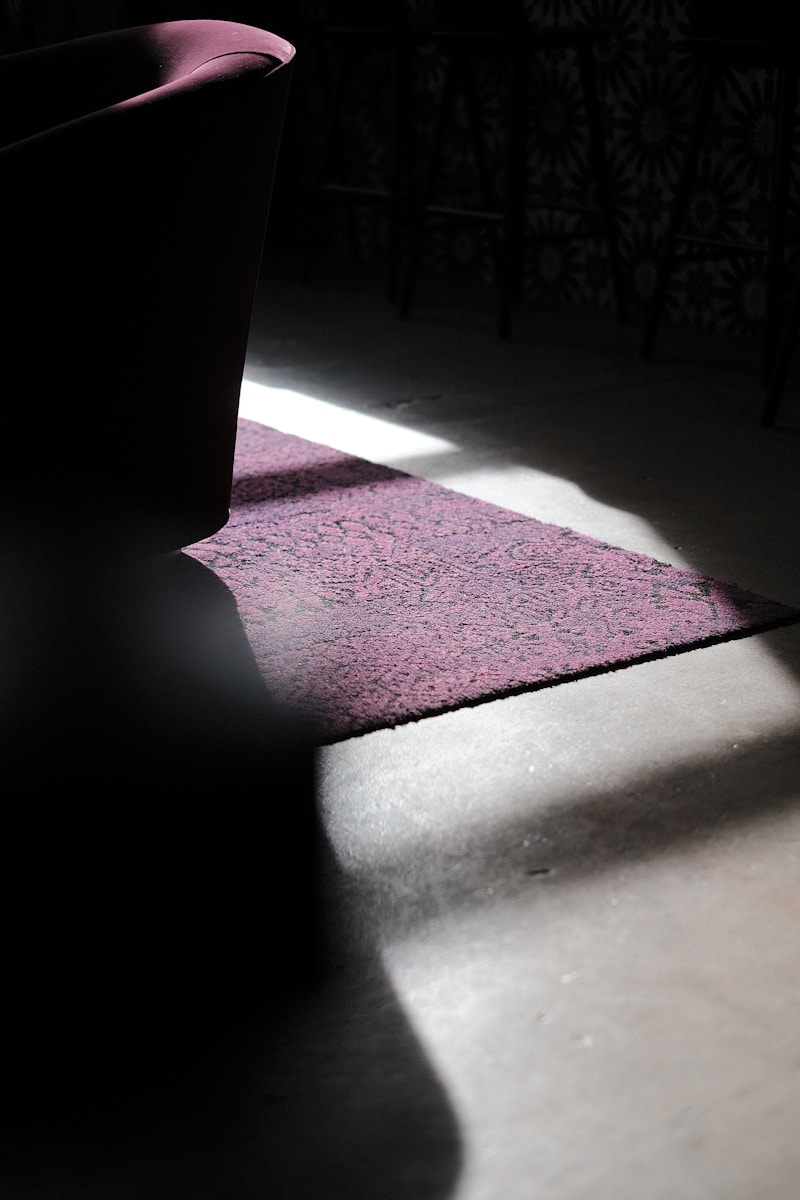 a chair and a rug in a dark room